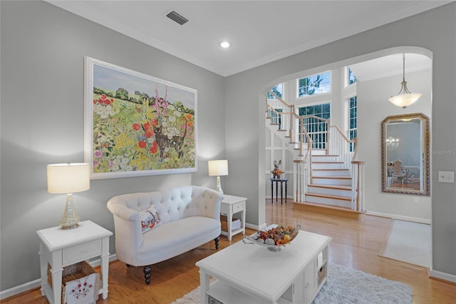 sitting room featuring hardwood / wood-style flooring and crown molding