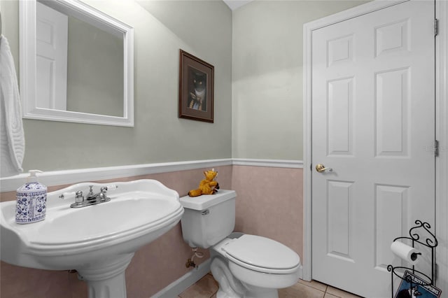 bathroom with toilet and tile patterned floors