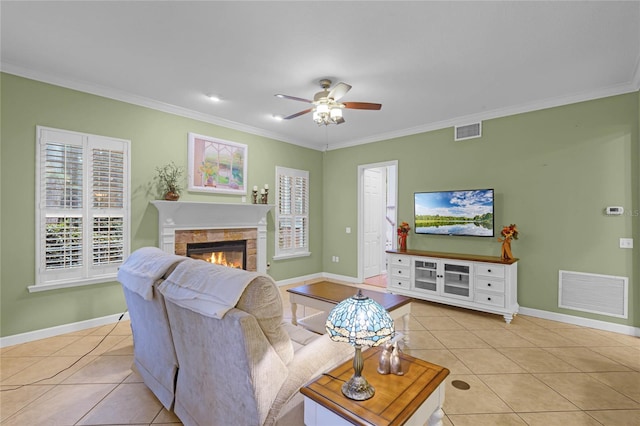 tiled living room with ceiling fan and crown molding