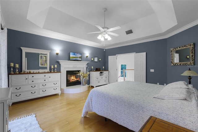 bedroom with access to exterior, light wood-type flooring, ceiling fan, and crown molding