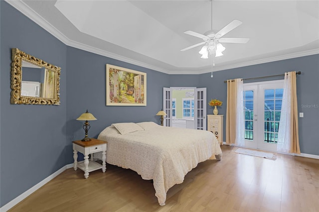 bedroom with crown molding, wood-type flooring, ceiling fan, and french doors