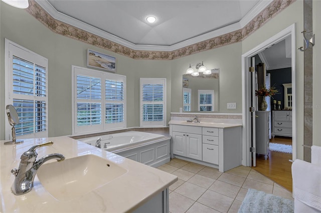 bathroom with ornamental molding, vanity, tile patterned floors, and a bath