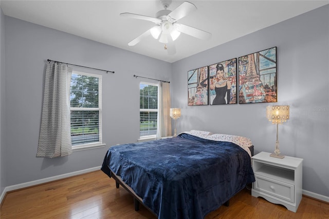 bedroom with hardwood / wood-style flooring and ceiling fan