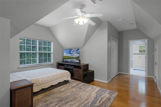 bedroom featuring a closet, lofted ceiling, ceiling fan, and light hardwood / wood-style flooring