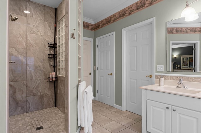 bathroom featuring vanity, tile patterned floors, tiled shower, and ornamental molding