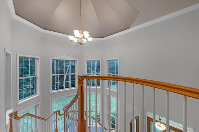 interior space featuring an inviting chandelier and crown molding