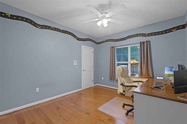 office area with wood-type flooring, a textured ceiling, and ceiling fan