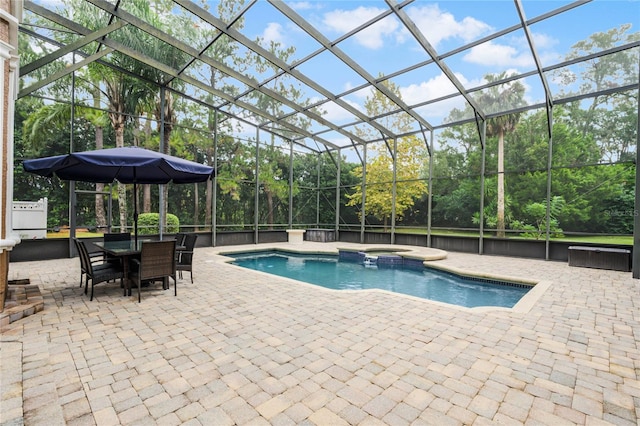 view of pool featuring a patio, a lanai, and an in ground hot tub