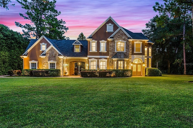 view of front of house with a yard and french doors