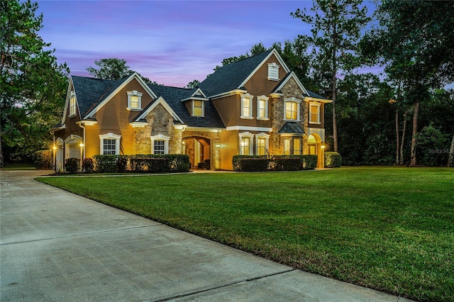 view of front of house featuring a garage and a yard