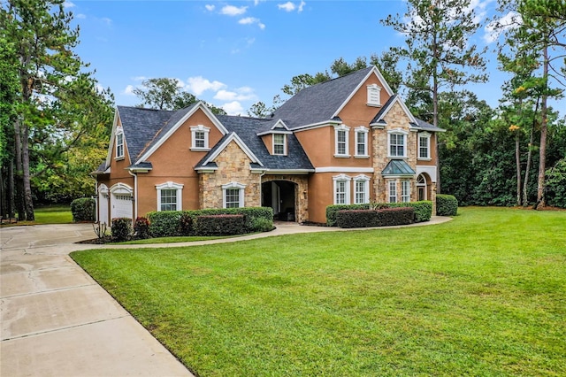 view of front of property featuring a garage and a front yard