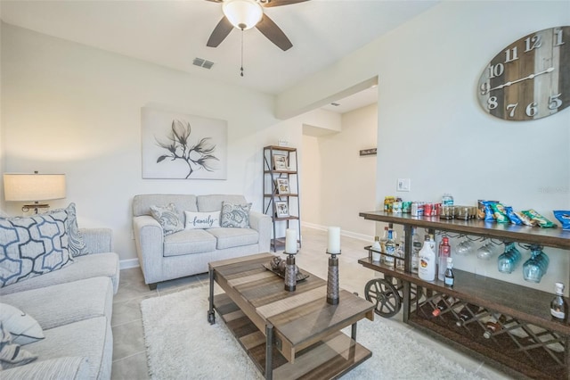 tiled living room featuring ceiling fan