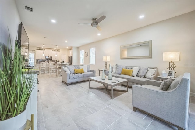 living room with ceiling fan and light tile patterned floors