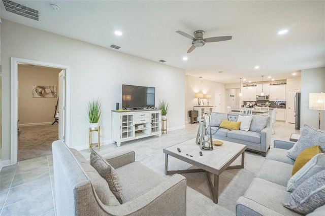 tiled living room featuring ceiling fan