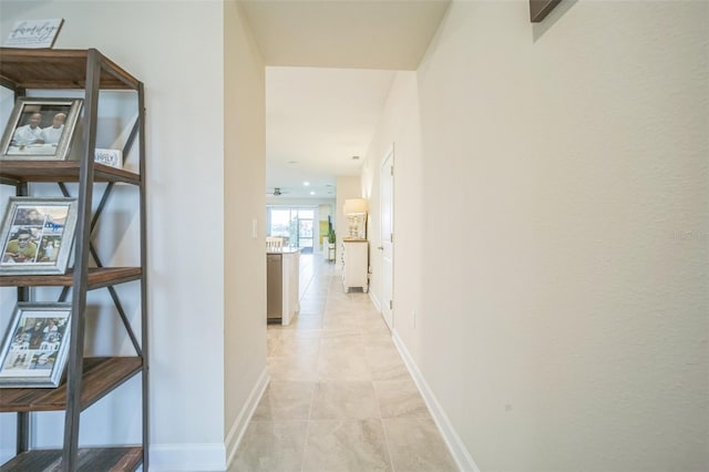 corridor with light tile patterned floors