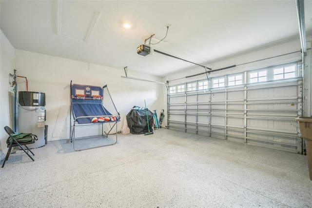 garage with heat pump water heater and a garage door opener