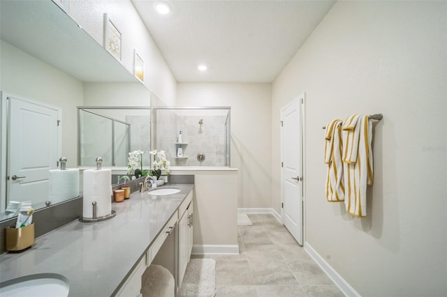 bathroom featuring vanity, tile patterned floors, and a shower with shower door