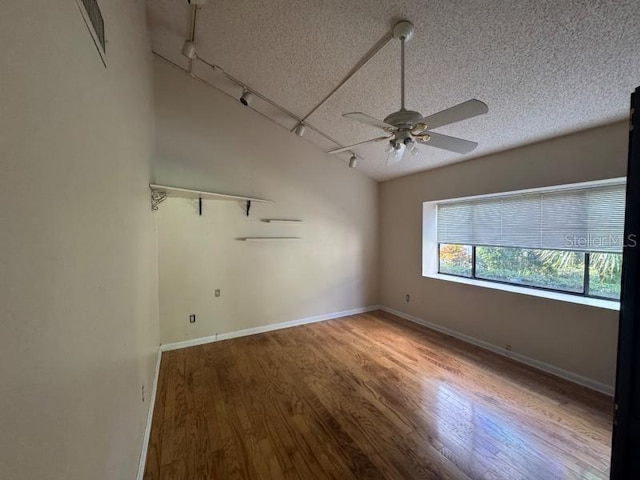 unfurnished room with hardwood / wood-style floors, ceiling fan, and a textured ceiling