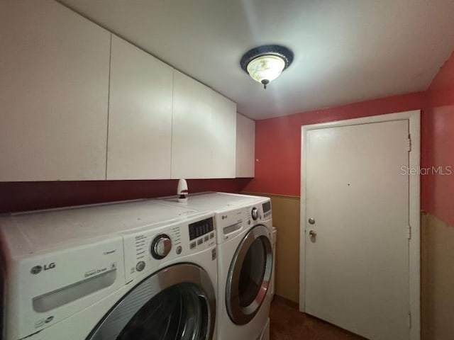 washroom with cabinets and washer and clothes dryer