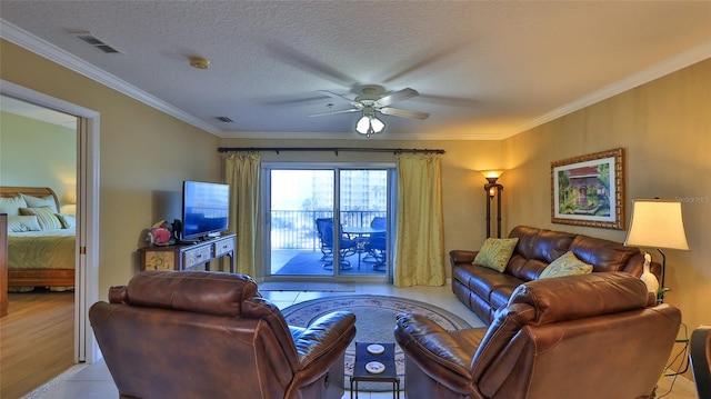 living room with ceiling fan, a textured ceiling, light hardwood / wood-style flooring, and crown molding