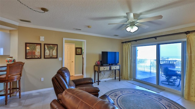 tiled living room with ornamental molding, a textured ceiling, and ceiling fan