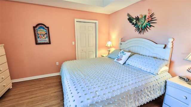 bedroom with dark hardwood / wood-style floors