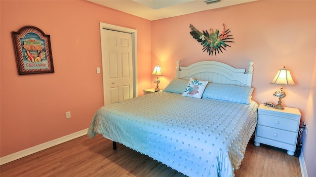 bedroom with hardwood / wood-style flooring and a closet