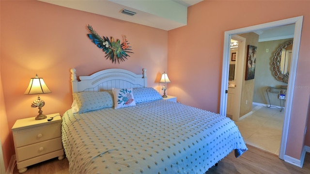 bedroom with hardwood / wood-style floors and crown molding