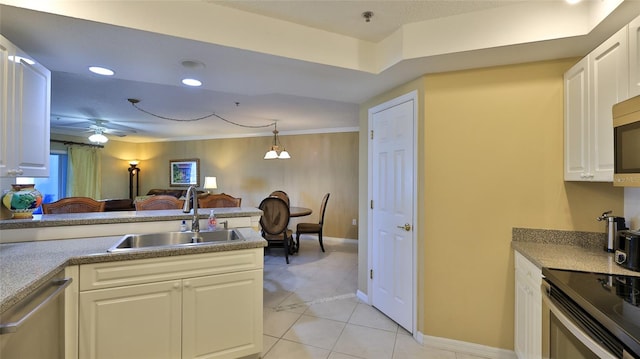 kitchen featuring stainless steel appliances, sink, ceiling fan, pendant lighting, and white cabinetry