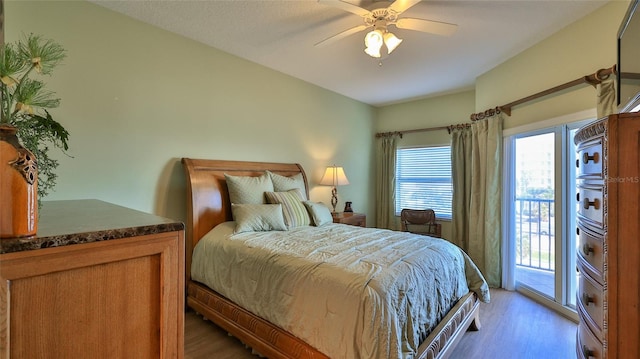 bedroom featuring access to outside, ceiling fan, and dark hardwood / wood-style floors