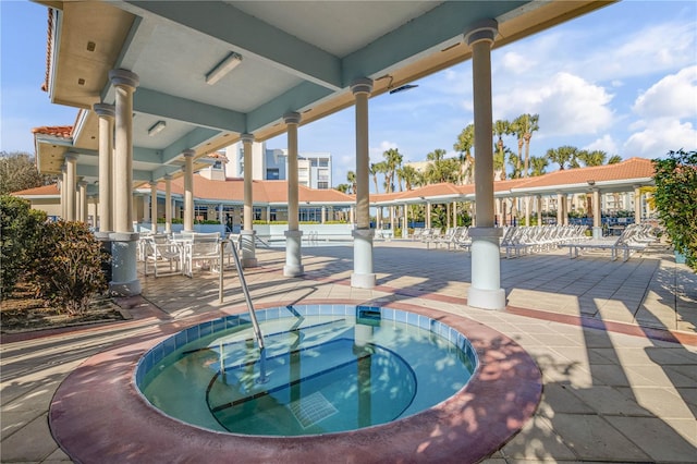 view of pool with a hot tub