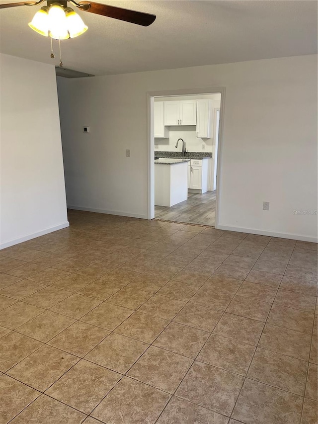 spare room featuring ceiling fan and sink