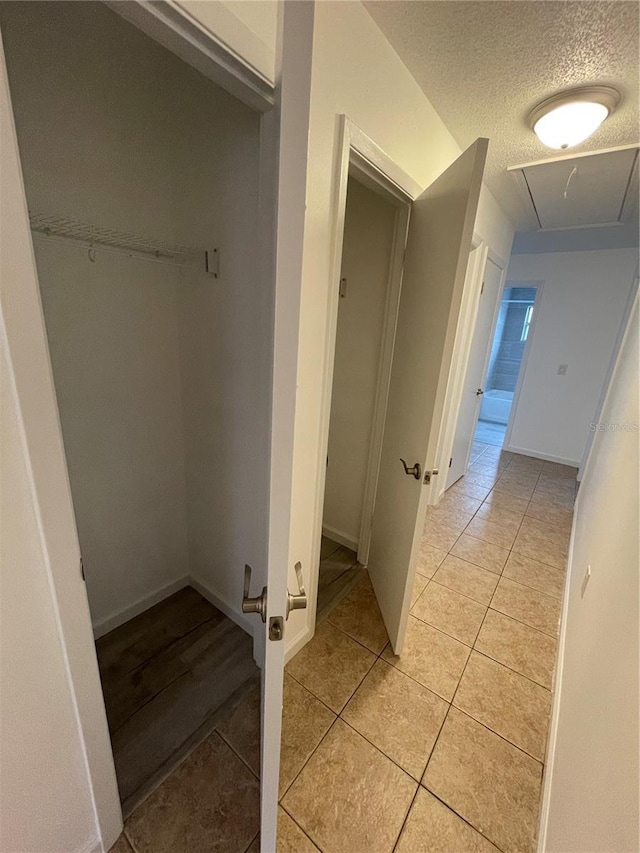 bathroom with tile patterned flooring and a textured ceiling