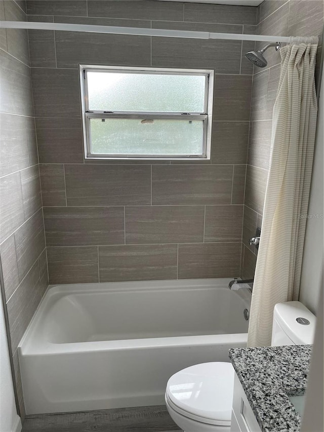 full bathroom featuring vanity, toilet, and shower / tub combo with curtain