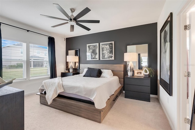 bedroom featuring light colored carpet and ceiling fan