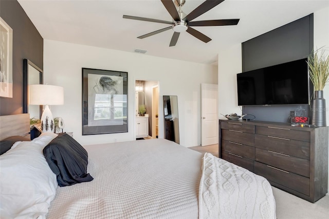 bedroom with ensuite bath and ceiling fan