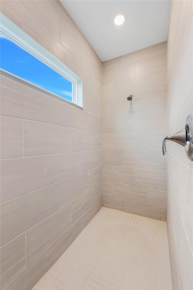 bathroom with a tile shower