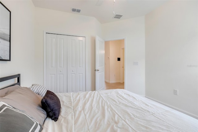 bedroom with ceiling fan and a closet