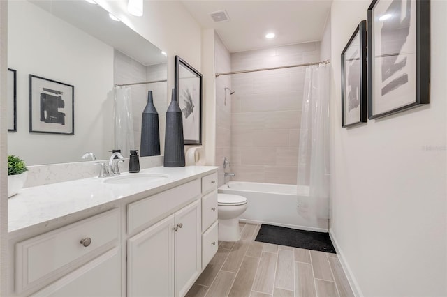 full bathroom with shower / tub combo, vanity, and toilet