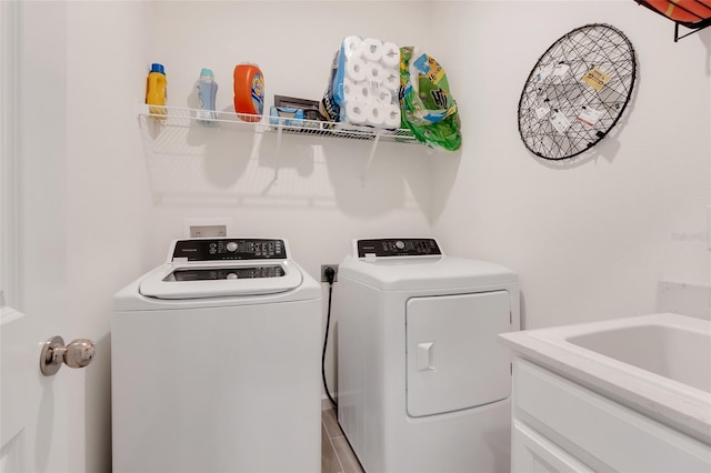 washroom with washer and dryer and sink