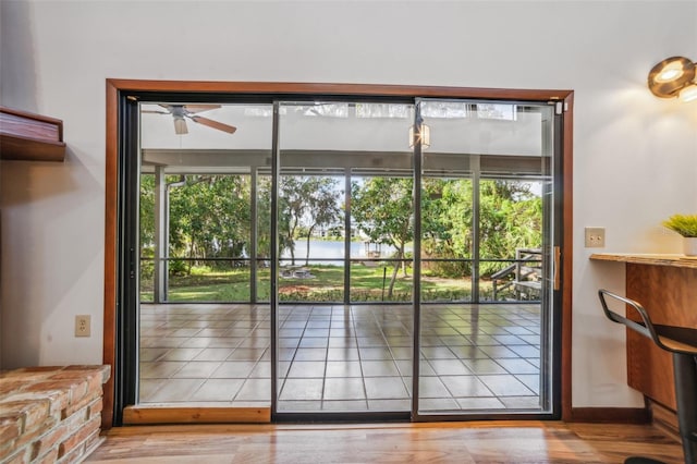 doorway to outside with ceiling fan and hardwood / wood-style flooring