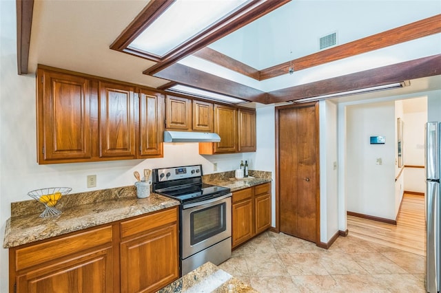 kitchen with light stone countertops, appliances with stainless steel finishes, and light wood-type flooring