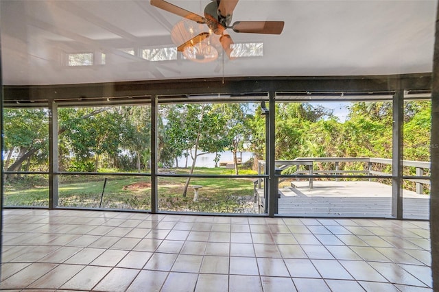 unfurnished sunroom featuring ceiling fan