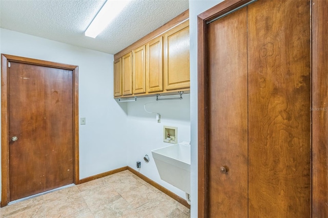 clothes washing area featuring cabinets, hookup for a gas dryer, sink, hookup for a washing machine, and a textured ceiling