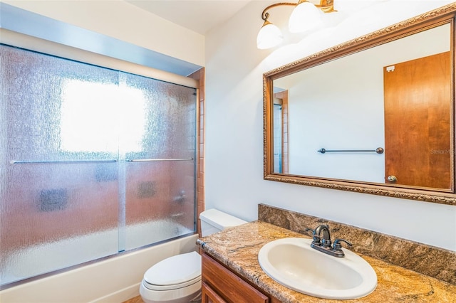 full bathroom with vanity, toilet, and enclosed tub / shower combo