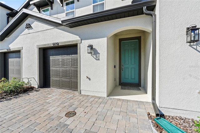 view of exterior entry featuring a garage