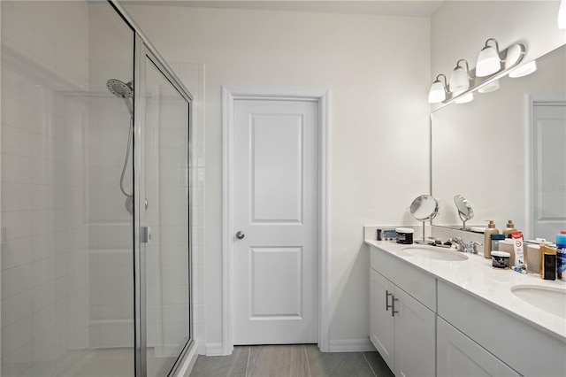 bathroom with vanity and a shower with shower door