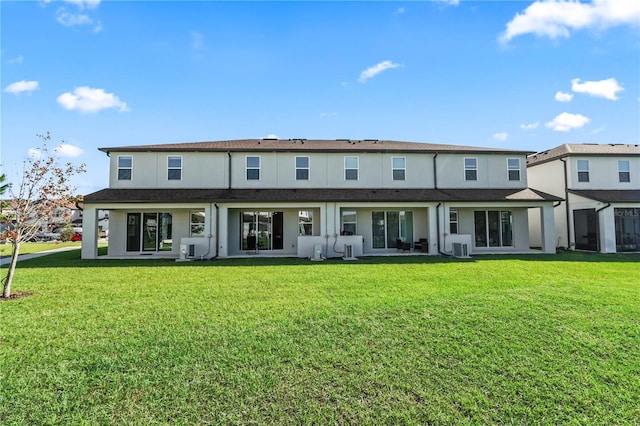 rear view of property with a yard