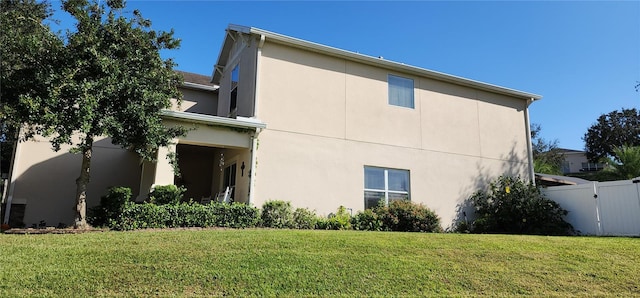 view of side of property with a lawn