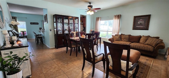 tiled dining space with ceiling fan